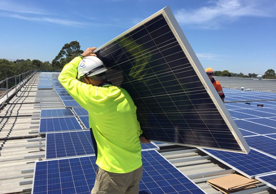 installing solar panels on roof of Baxter site in Toongabbie Australia